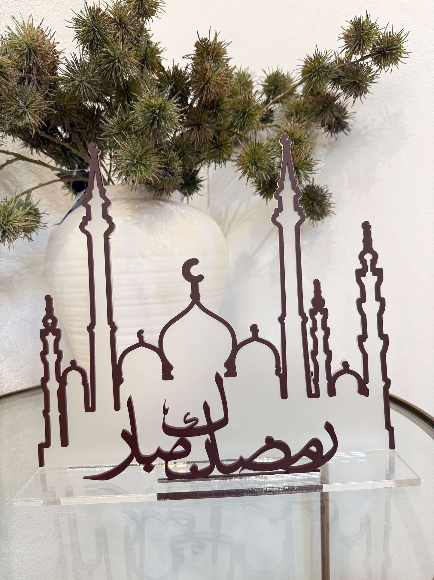 Decorative metal wall art with a castle design on a white background